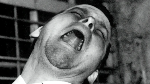 Black and white close-up of a man shouting with his head thrown back