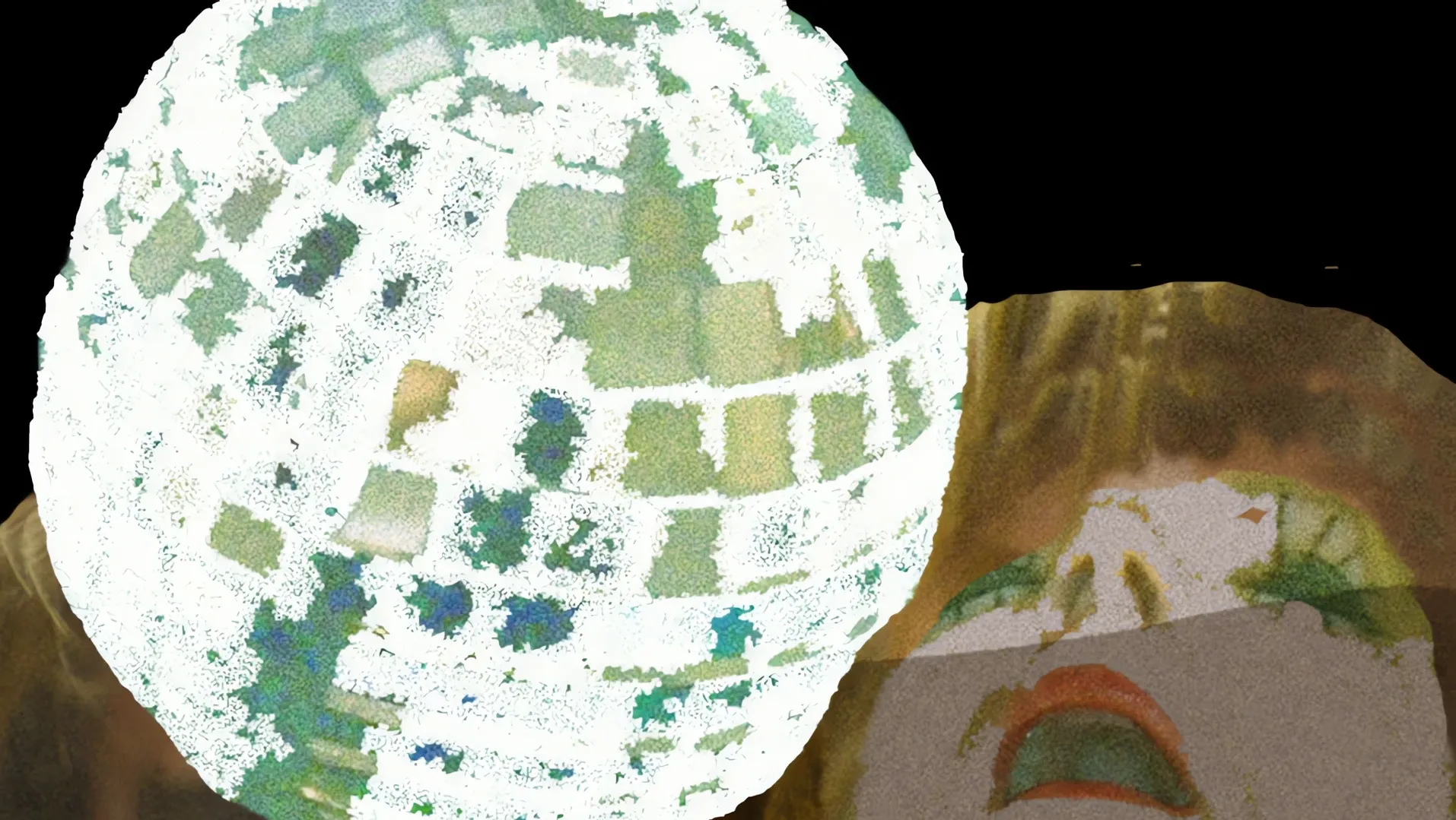 A large patchwork sphere against a dark background