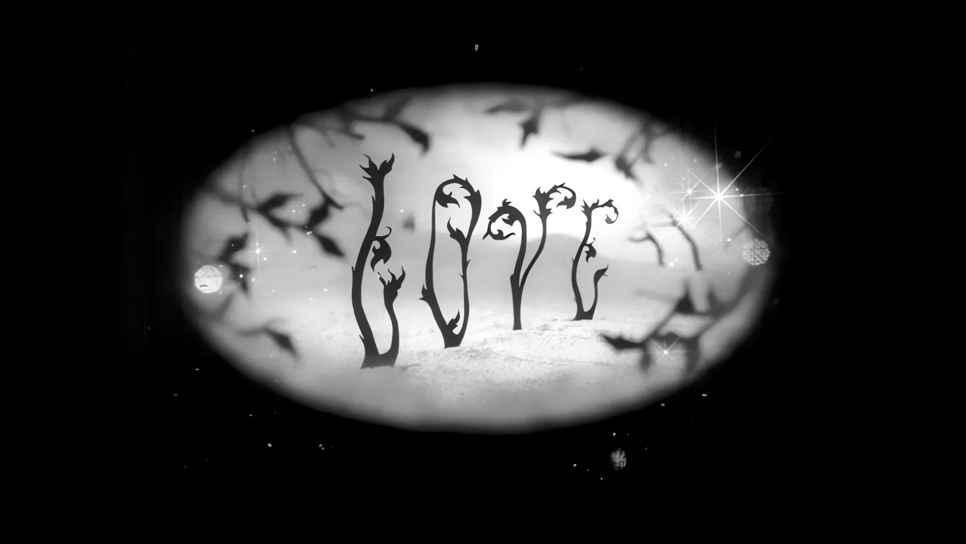 The word love written in a white oval on black