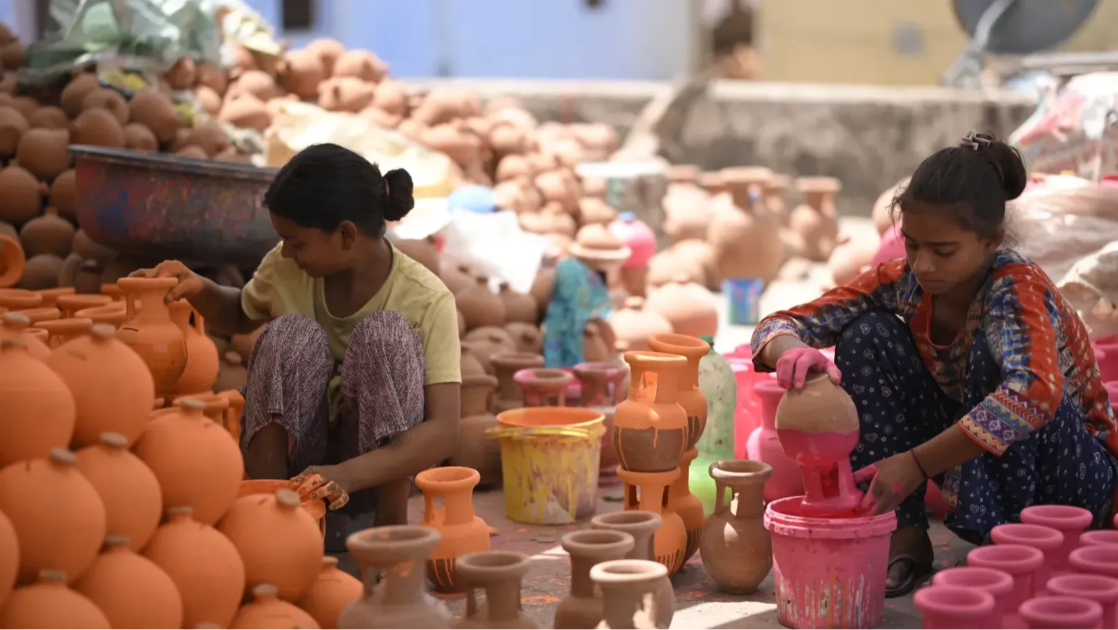 Artisans are working on decorating pottery products in Baswa Village, Rajasthan, India
